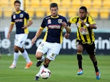 Central Coast's Nick Montgomery and Wellington's Kenny Cunningham in action during their A-League match on January 12, 2014