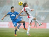 Getafe's Pablo Sarabia and Rayo Vallecano's Raul Baena in action during their La Liga match on January 12, 2014