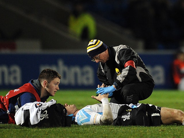 Paul Warwick of Worcester Warriors receives treatment on the field during the Amlin Challenge Cup match between Sale Sharks and Worcester Warriors at the AJ Bell Stadium on January 10, 2014