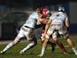 Scarlets' Welsh flanker Aaron Shingler challenges Racing Metro's Fijian flanker Sakiusa Matadigo and flanker Dan Lydiate during the European Cup rugby union match between Racing Metro and Scarlets at the Yves du Manoir stadium in Colombes on January 10, 2
