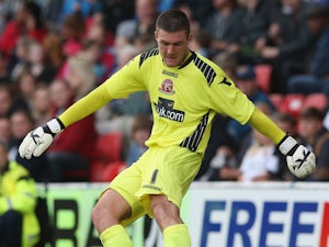 Richard O'Donnell of Walsall kicks the ball upfield during the pre season friendly match between Walsall and Aston Villa at the Banks' Stadium on July 31, 2013