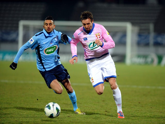 Evian's Swiss defender Fabrice Ehret vies with Le Havre's French forward Riyad Mahrez during their French Cup football match Evian (ETGFC) vs Le Havre (HAC) on February 26, 2013