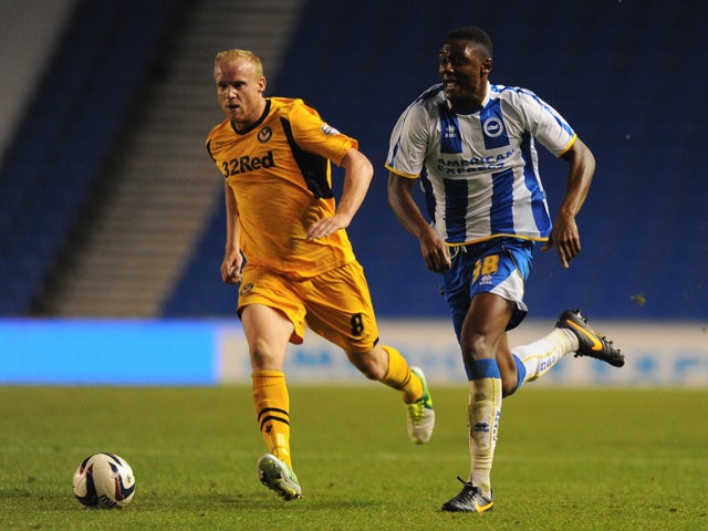 Rohan Ince of Brighton is challenged by Lee Minshull of Newport during the Capital One Cup First Round match between Brighton & Hove Albion and Newport County at Amex Stadium on August 6, 2013
