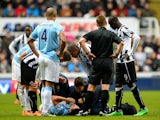 Samir Nasri of Manchester City receives medical attention after the tackle from Mapou Yanga-Mbiwa of Newcastle during the Barclays Premier League match on January 12, 2014