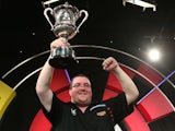 Stephen Bunting of England celebrates with the trophy after winning the final against Alan Norris of England during the BDO Lakeside World Professional Darts Championship on January 12, 2014