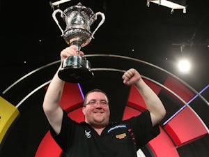 Stephen Bunting of England celebrates with the trophy after winning the final against Alan Norris of England during the BDO Lakeside World Professional Darts Championship on January 12, 2014