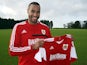 Tyrone Barnett poses with a Bristol City shirt after signing on loan for the Robins on January 8, 2014