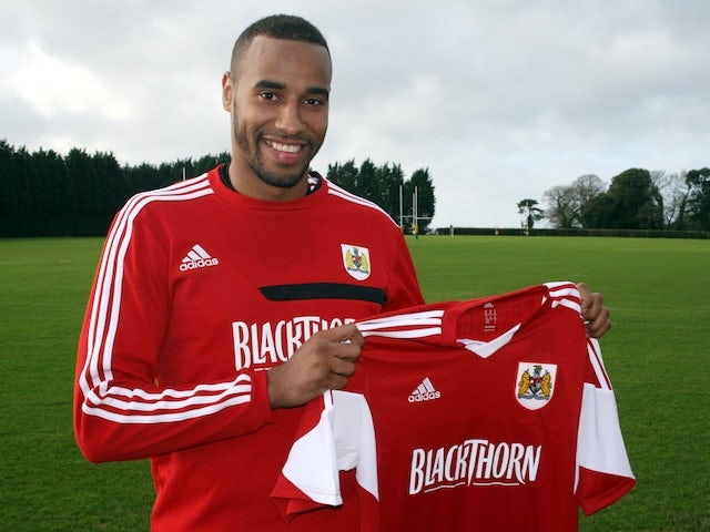 Tyrone Barnett poses with a Bristol City shirt after signing on loan for the Robins on January 8, 2014