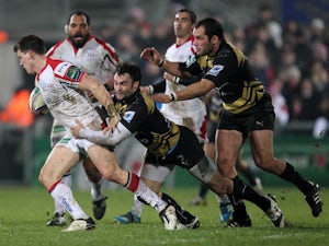 Montpellier's French centre Thomas Combezou tackles Ulster's Irish wing Craig Gilroy during the European Cup rugby union match between Ulster and Montpellier at Ravenhill Stadium in Belfast, Northern Ireland on January 10, 2014