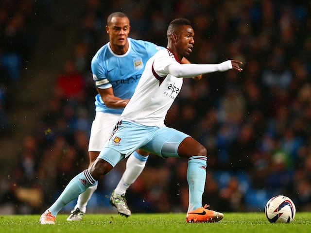 Vincent Kompany of Manchester City marks Modibo Maiga of West Ham during the Capital One Cup Semi-Final first leg match between Manchester City and West Ham United on January 8, 2014