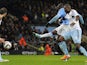 Manchester City's Ivorian midfielder Yaya Toure (2R) scores his team's third goal as West Ham United's Ivorian defender Guy Demel (R) defends during the English League Cup semi-final on January 8, 2014