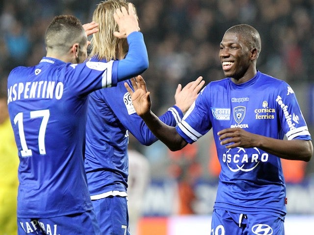 Bastia's Mauritanian midfielder Adama Ba is congratulated by teammates after scoring during the French L1 football match against Bordeaux on January 18, 2014