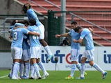 Lazio's Anderson Hernanes is mobbed by teammates after scoring his team's third goal against Udinese during their Serie A match on January 19, 2014