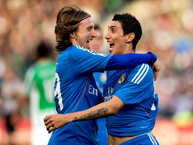 Real's Angel Di Maria celebrates with teammate Luka Modric