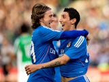 Real's Angel Di Maria celebrates with teammate Luka Modric after scoring his team's fourth goal against Real Betis during their La Liga match on January 18, 2014