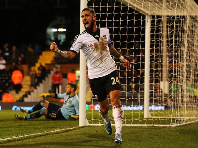 Fulham's Ashkan Dejagah celebrates after scoring his team's second goal against Norwich during their FA Cup third round replay match on January 14, 2014