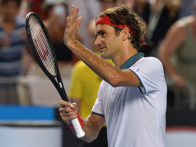 Switzerland's Roger Federer acknowledges fans after his victory against Slovenia's Blaz Kavcic during their men's singles match on day four of the 2014 Australian Open tennis tournament in Melbourne on January 16, 2014