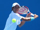 Kei Nishikori of Japan plays a backhand in his second round match against Dusan Lajovic of Serbia during day four of the 2014 Australian Open at Melbourne Park on January 16, 2014