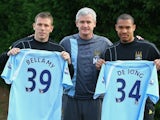 Mark Hughes, then manager of Manchester City, unveils his new signings Craig Bellamy and Nigel de Jong on January 19, 2009.