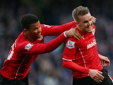 Craig Noone of Cardiff is congratulated by teammate Fraizer Campbell after scoring a goal to level the scores at 1-1 during the Barclays Premier League
