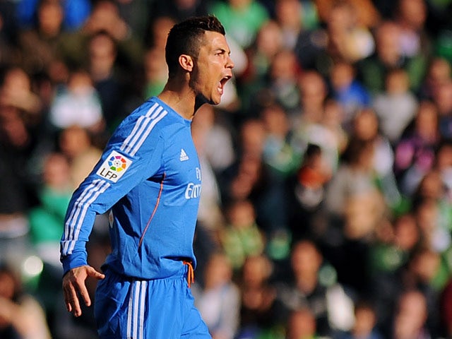 Real's Cristiano Ronaldo celebrates after scoring the opening goal against Real Betis during their La Liga match on January 18, 2014