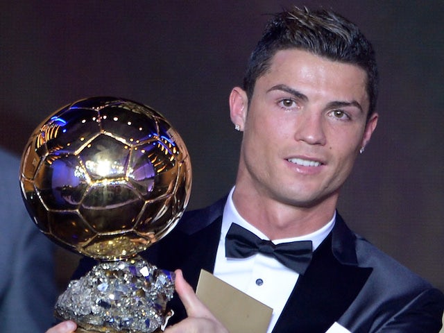 Real Madrid's Portuguese forward Cristiano Ronaldo poses with the 2013 FIFA Ballon d'Or award for player of the year during the FIFA Ballon d'Or award ceremony on January 13, 2014