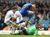 Leicester's David Nugent jumps over Leeds goalkeeper Paddy Kenny as he scores the opening goal during their Championship match on January 18, 2014