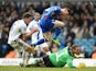 Leicester's David Nugent jumps over Leeds goalkeeper Paddy Kenny as he scores the opening goal during their Championship match on January 18, 2014
