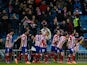 Atletico Madrid's Diego Godin celebrates with teammates after scoring the opening goal against Valencia during their Copa del Rey match on January 14, 2014