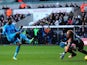 Tottenham's Emmanuel Adebayor scores his team's third goal against Swansea during their Premier League match on January 19, 2014