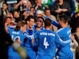 Real's Gareth Bale is congratulated by teammates after scoring his team's second goal via the penalty spot against Real Betis during their La Liga match on January 18, 2014