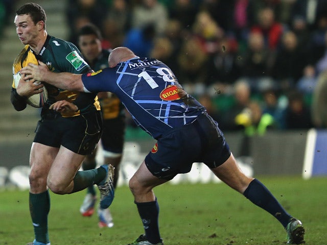 Northampton Saints' George North tangles with Castres' Mihaita Lazar during their Heineken Cup match on January 17, 2014