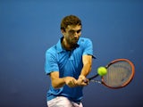 France's Gilles Simon plays a shot during his men's singles match against Croatia's Marin Cilic on day four of the 2014 Australian Open tennis tournament in Melbourne on January 16, 2014