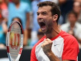 Grigor Dimitrov celebrates after his win over Milos Raonic during their Australian Open third round match on January 18, 2014