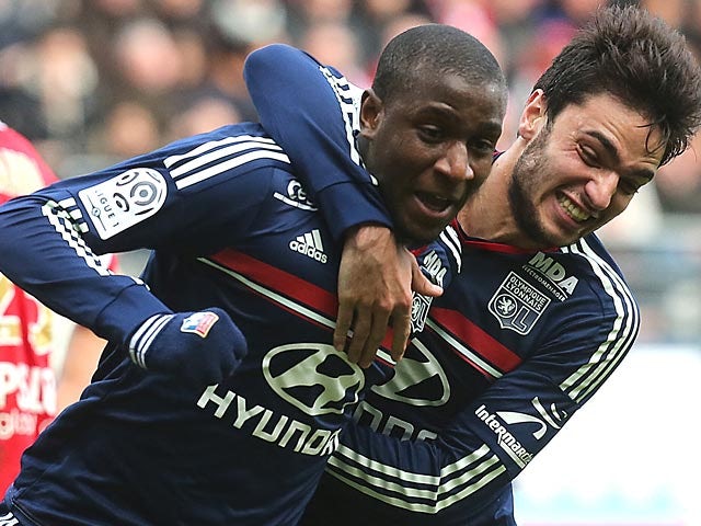 Lyon's Gueida Fofana celebrates with teammate Clement Grenie after scoring his team's second goal against Reims during their Ligue 1 match on January 19, 2014