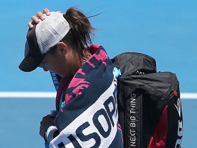 Heather Watson of Great Britain walks off after losing her first round match against Daniela Hantuchova of Slovakia during day one of the 2014 Australian Open on January 13, 2014