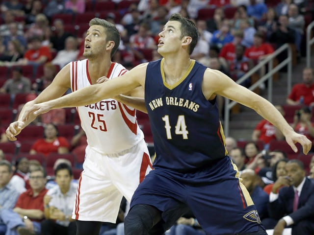 Jason Smith #14 of the New Orleans Pelicans blocks out Chandler Parsons #25 of the Houston Rockets in a preseason NBA game on October 5, 2013