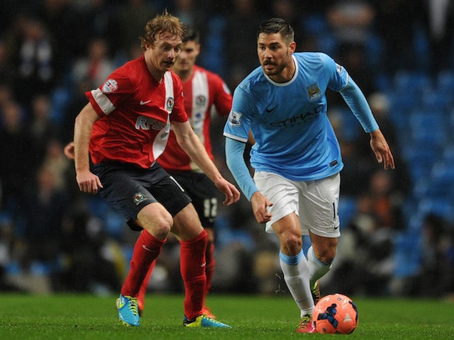 Javi Garcia of Manchester City competes with Chris Taylor of Blackburn Rovers during the Budweiser FA Cup Third Round Replay match on January 15, 2014