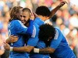 Real's Karim Benzema is congratulated by teammates after scoring his team's third goal against Real Betis during their La Liga match on January 18, 2014