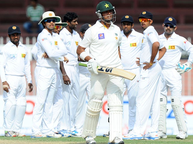 Pakistani batsman Khurram Manzoor leaves the field against being dismissed during the match against Sri Lanka on January 18, 2014