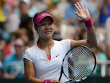 Li Na celebrates after her win over Katerina Makarova in their Australian Open fourth round match on January 19, 2014