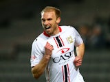 MK Dons' Luke Chadwick celebrates after scoring the opening goal against Wigan during their FA Cup third round replay match on January 14, 2014