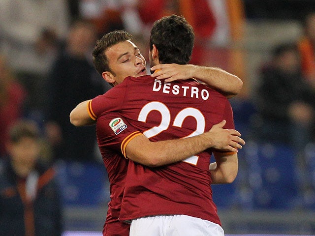 Roma's Mattia Destro celebrates with teammate Adem Ljaijc after scoring the opening goal against Livorno Calcio during their Serie A match on January 18, 2014