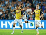 Central Coast Mariners' Mile Sterjovski celebrates with teammates after scoring the opening goal against Sydney on January 18, 2014