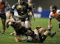 Montpellier's Lucas Dupont (L) is tackled by Treviso's James Ambrosini (R) during the European Cup rugby union match Montpellier vs Treviso at the Yves du Manoir stadium on January 18, 2014
