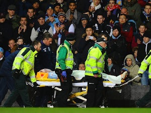 Nathan Baker of Aston Villa is stretchered off during the Barclays Premier League match between Aston Villa and Arsenal at Villa Park on January 13, 2014