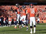 Jacob Tamme #84 celebrates his second quarter touchdown with Eric Decker #87 as Peyton Manning #18 of the Denver Broncos looks on during their AFC Championship game against the New England Patriots at Sports Authority Field at Mile High on January 19, 201