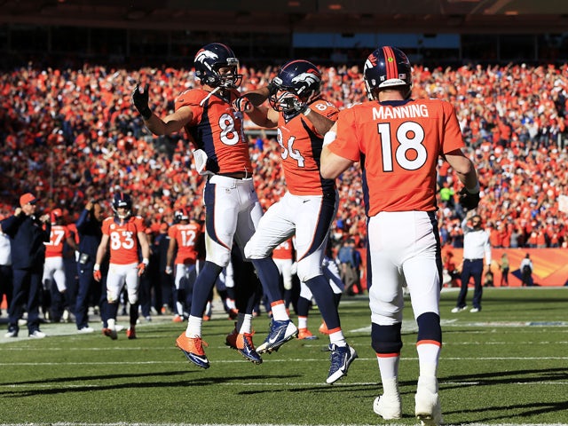Jacob Tamme #84 celebrates his second quarter touchdown with Eric Decker #87 as Peyton Manning #18 of the Denver Broncos looks on during their AFC Championship game against the New England Patriots at Sports Authority Field at Mile High on January 19, 201
