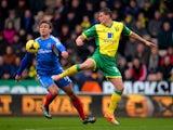 Nikica Jelavic of Hull City and Ryan Bennett of Norwich City compete for the ball during the Barclays Premier League match on January 18, 2014