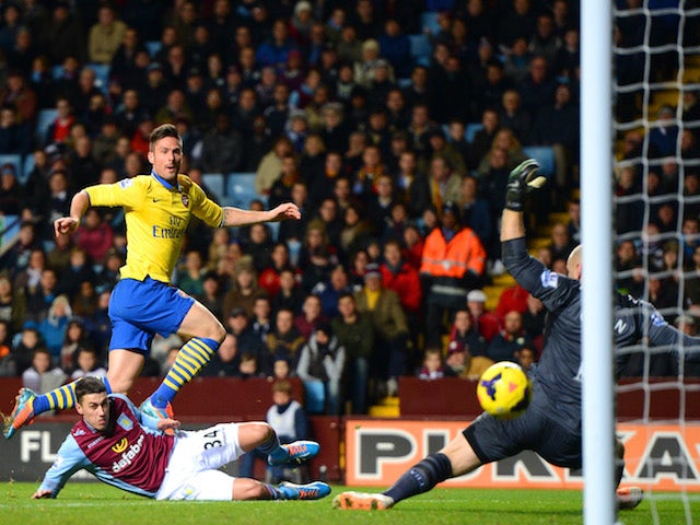 Olivier Giroud of Arsenal scores their second goal past Brad Guzan of Aston Villa during the Barclays Premier League match on January 13, 2014